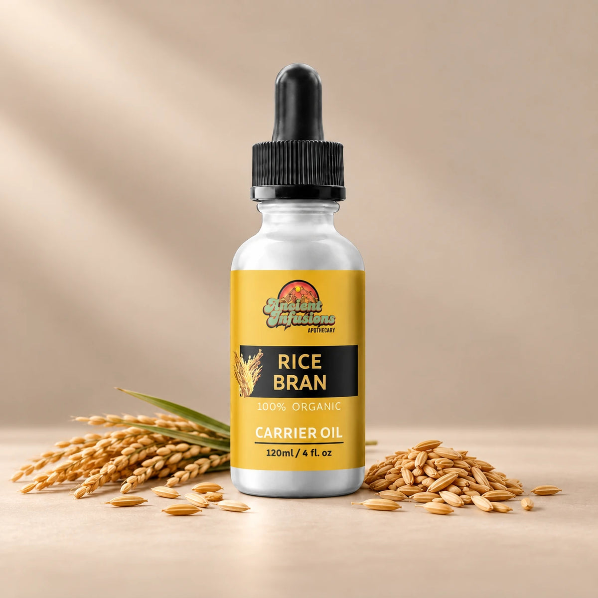 Ancient Infusions Rice Bran Carrier Oil silver bottle with black dropper on a warm stone background.