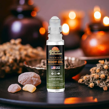 Sabatt Body Oil bottle with ancient infusion, surrounded by mystical herbs and dark resins, evokes rich and earthy aromas, alcohol-free blend.