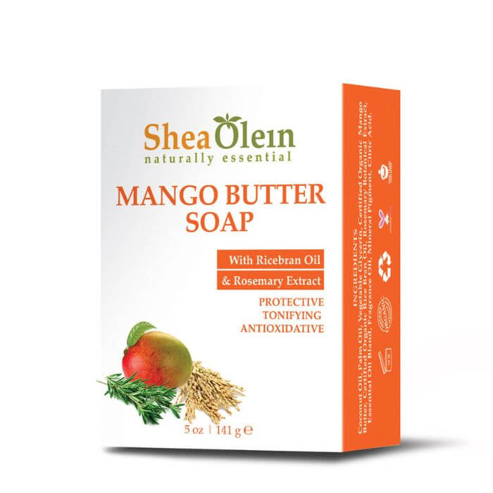 Shea Olein Mango Butter Soap with upright box, mango, rosemary, and rice bran on wood counter – antioxidant and toning bar for daily skin care.