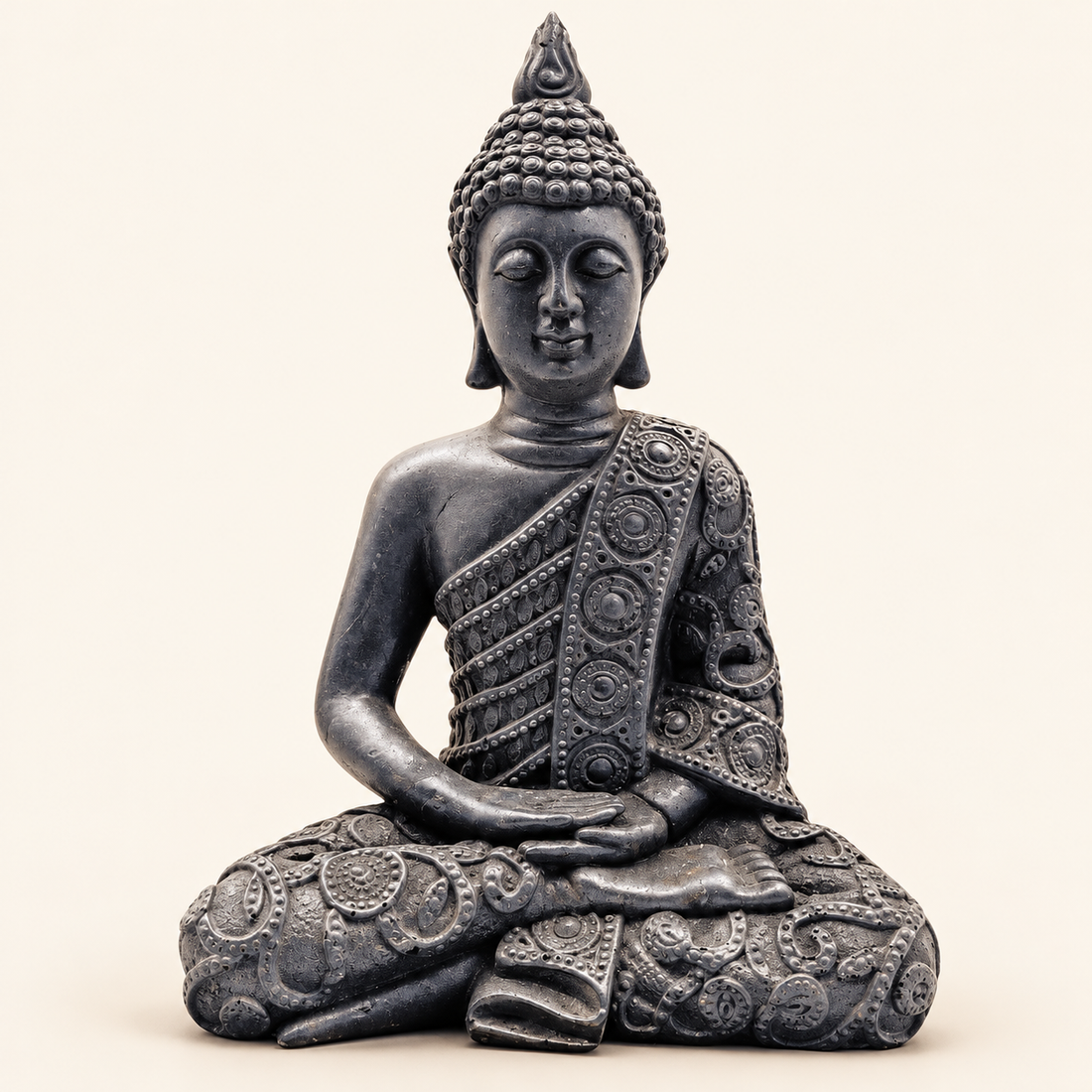 Shungite Carved Buddha with deep charcoal tones on a soft ivory background