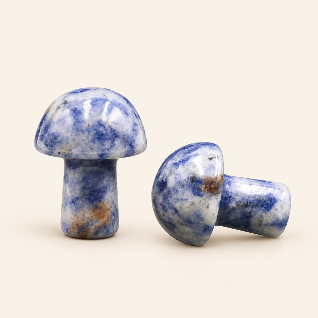 Sodalite Carved Mushroom with blue tones with white markings on a soft ivory background