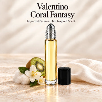 Valentino Coral Fantasy Perfume Oil in a slim glass roll-on bottle with a silver roller and black cap on an ivory stone surface.