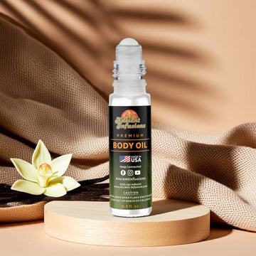 Vanilla body oil roll-on bottle with soft cream tones and vanilla beans on wooden table