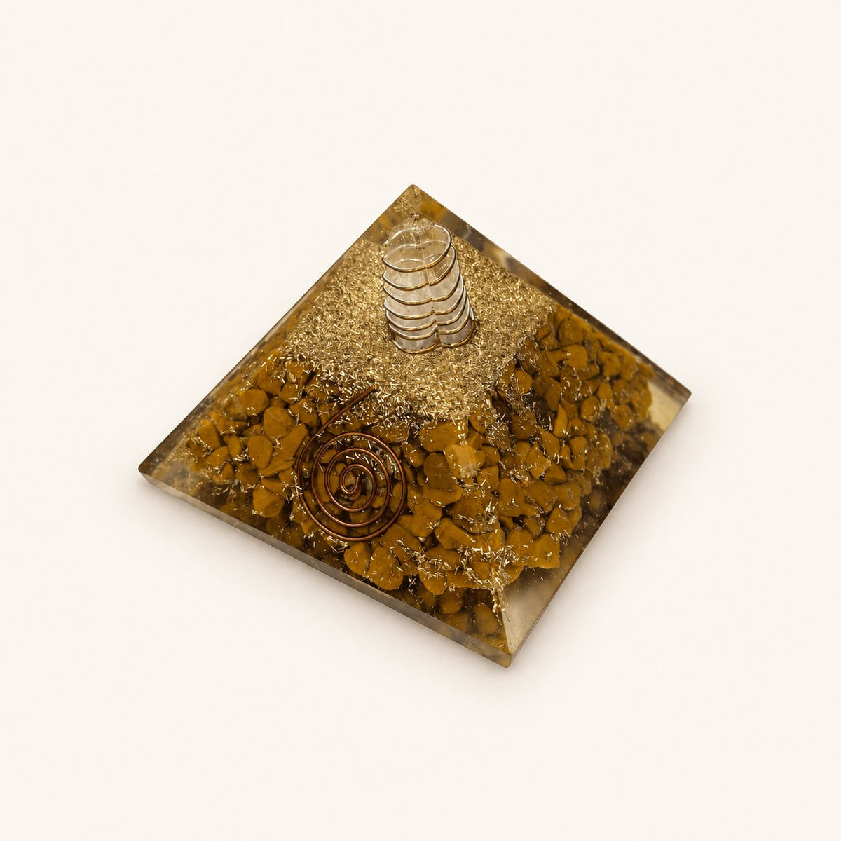 Yellow Jasper Orgone Pyramid with ochre-yellow jasper chips and metallic details on a warm ivory background