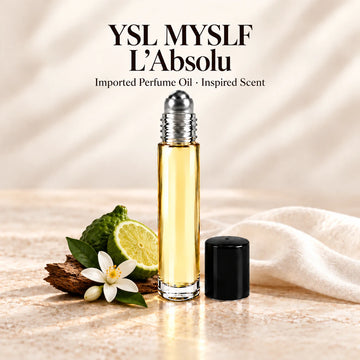 YSL MYSLF L'Absolu Perfume Oil in a slim glass roll-on bottle with a silver roller and black cap on an ivory stone surface.